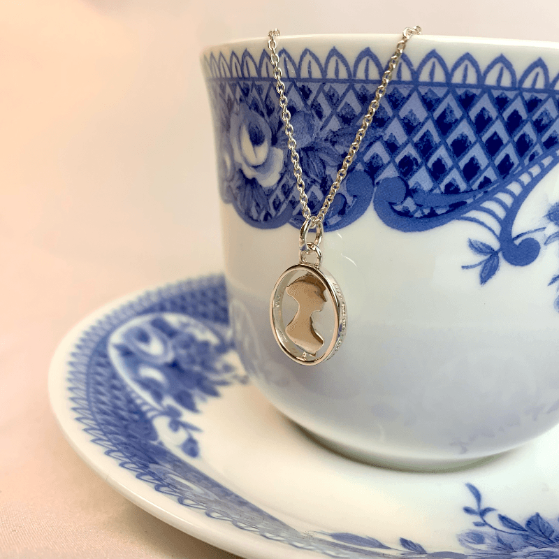 here you can see the jane austen silhouette necklace hung from a regency teacup. This demonstrates the shine of the sterling silver and shows the small size of the pendent. The jane austen necklace makes a lovely gift for a jane austen fan or a lover of pride and prejudice